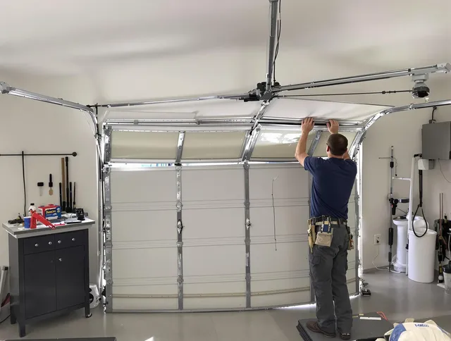 East Windsor Garage Door Repair specialist performing precise section replacement on East Windsor garage door